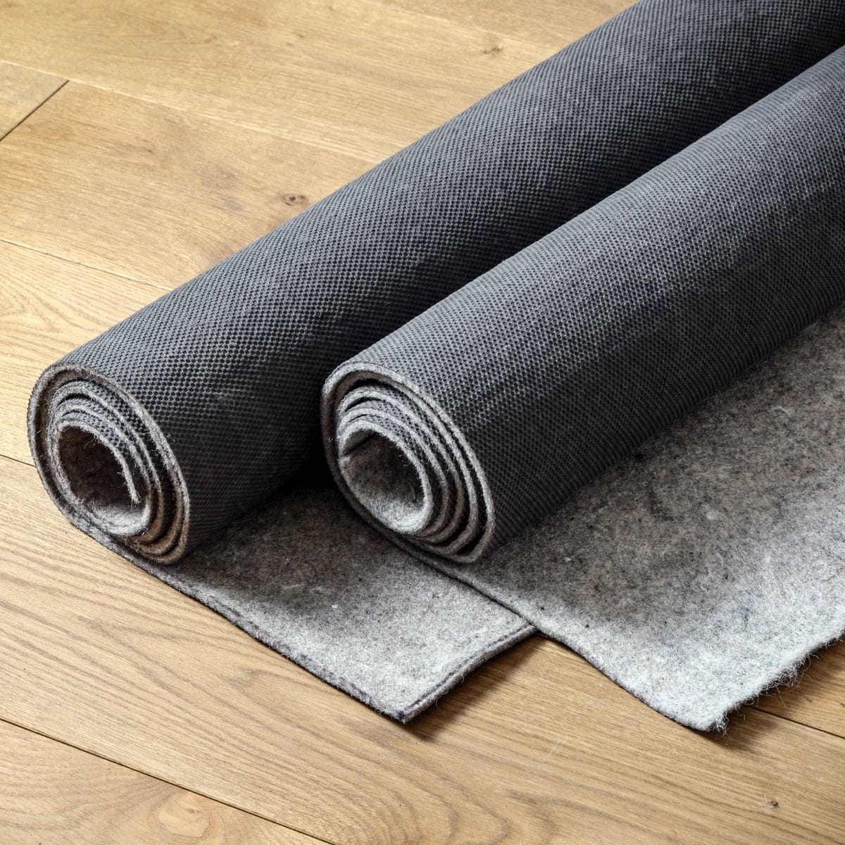 Premium rug pad underneath a luxury area rug